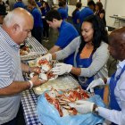 Lemoore Rotarian Buzz Felleke dished out crowd to hungry dinners at Saturday night's annual crab feed.
